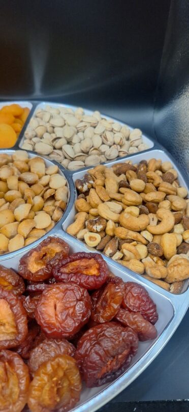 plums, mixed nuts and pistachios in platter