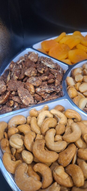 partial view of Cashews, praline pecans and apricots in platter